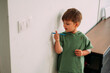 Naughty child drawing the wall of his house