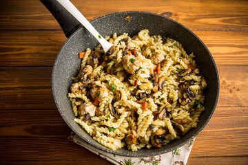 Sticker - vermicelli cooked with mushrooms, meat and vegetables in a frying pan