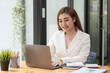 © Songsak C - Asian Businesswoman working on a laptop at her desk at the office.