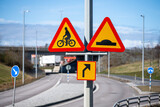 Fototapeta Miasto - Signs warning of a bicycle crossing to the right.