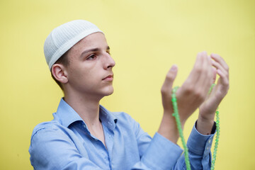 young muslim man praying, concept of peace, harmony and happy life filled with belief in God