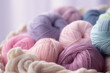Close Up of yarn balls. Purple pink pastel colors. Yarn for knitting. Skeins of yarn. Knitting needles, colorful threads. Knitting wallpaper background. Generative AI professional photo imitation.