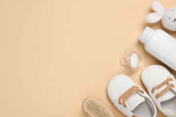 Wall Mural - Flat lay composition with pacifier and other baby stuff on beige background. Space for text