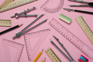 Wall Mural - Flat lay composition with different rulers and stationery on pink background