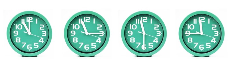 close up of a set of green clocks showing the time; 11, 11.15, 11.30 and 11.45 p.m or a.m. Isolated on white background
