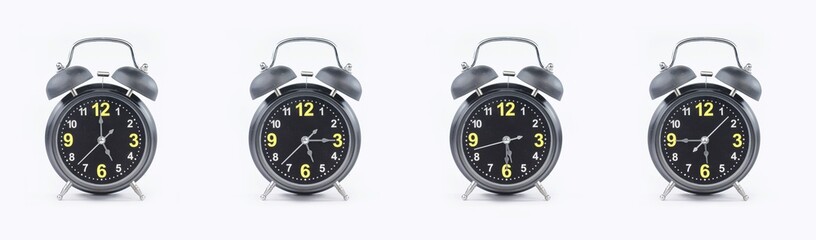 close up of a set of black alarm clocks showing the time; 5, 5.15, 5.30 and 5.45 p.m dan a.m. Isolated on white background
