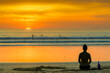 © robertharding - Girl and surfers silhouetted by sunset at this hip surf beach and yoga destination, Playa Guiones, Nosara, Guanacaste, Costa Rica