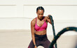 © Emil Lime/peopleimages.com - Woman, fitness and battle rope exercise for physical workout, training or wellness in the outdoors. Fit, active or serious female person exercising with ropes for intense endurance, stamina or cardio