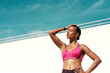 © Emil L/peopleimages.com - Sunshine, fitness and relax, woman with mockup on blue sky at outdoor gym for health and wellness with space. Workout, exercise and athlete with focus, sweat and healthy mindset for fit summer goals.