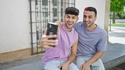 Wall Mural - Two men couple smiling confident having video call at street