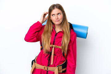 Wall Mural - Young mountaineer girl with a big backpack over isolated white background having doubts and with confuse face expression