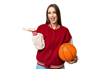 Canvas Print - Young beautiful woman playing basketball over isolated chroma key background with shocked facial expression