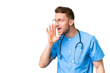 Wall Mural - Young nurse man over isolated chroma key background shouting with mouth wide open to the lateral