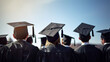 © JPDC - Back view of graduates in gowns and caps on graduation day against a blue sky background. A.I. generated.