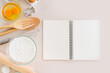 Blank notepad on a white background. Culinary cooking baking concept, place for a recipe. Top view.