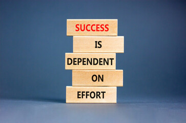 Wall Mural - Success and effort symbol. Concept words Success is dependent on effort on wooden block. Beautiful grey table grey background. Business success and effort concept. Copy space.