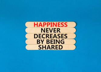 Wall Mural - Happiness symbol. Concept words Happiness never decreases by being shared on wooden stick. Beautiful blue table blue background. Motivational Happiness concept. Copy space.