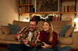 © Stockphotodirectors - Young couple having fun at home playing video games