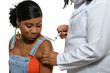 © Edson Souza - a black teenager being vaccinated in the arm by a health professional