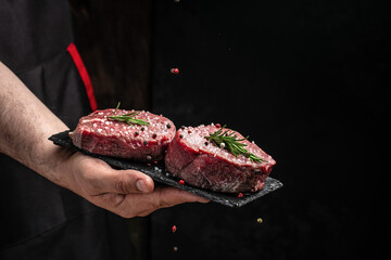 Canvas Print - Beef medallions with rosemary and spices, Raw beef meat steak Tenderloin fillet on a dark background. banner, menu, recipe place for text, top view