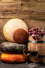 Whole Round Head Of Parmesan Or Parmigiano Hard Cheese And Wine On A Wooden Background. Farmer Market. Place For Text