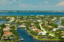 Aerial View Of Residential Suburbs With Private Homes Located On Gulf Coast Near Wildlife Wetlands With Green Vegetation On Sea Shore. Living Close To Nature Concept