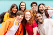 © Xavier Lorenzo - Diverse group of teenage student friends standing together over blue background. Portrait of young multiracial college people team having fun smiling at camera. Youth community and friendship concept