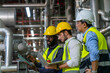 © CandyRetriever  - Group of Diversity electrical engineer in safety uniform working together at factory site control room. Industrial technician worker maintenance and checking power system at manufacturing plant room.