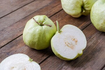 Guava fruits on a wooden table. Malaysian people are called Jambu Batu.