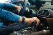 Leinwandbild Motiv Close-up of a man's hand while shifting the automatic transmission of a car.