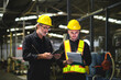 © VStudio - Two operators inspecting oil in industrial factory, standing holding document and tablet for check, background in industrial warehouse., middle-aged male worker, Caucasian.