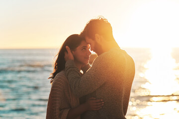 sunset, beach and couple touching face for relaxing, bonding and quality time on romantic date. natu