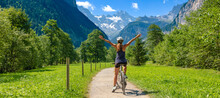 Happy Woman With Open Arms On Bike- Switzerland- Travel,  Sport,  Active Woman Concept