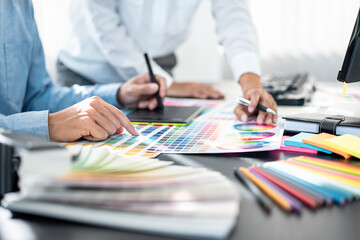Poster - Team of creative graphic designer working on color swatch samples chart for selection coloring in inspiration to create new collection at workplace