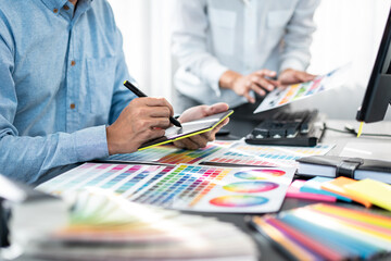 Poster - Team of creative graphic designer working on color swatch samples chart for selection coloring in inspiration to create new collection at workplace