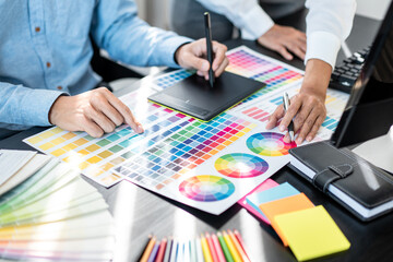 Poster - Team of creative graphic designer working on color swatch samples chart for selection coloring in inspiration to create new collection at workplace