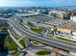 Krakow, Poland. Cityscape with Main railroad station with big parking lot on its roof. Elevated city highway with junctions, rotary and ramps. Old town far view with main monuments in the background