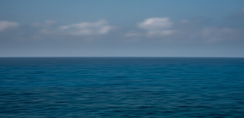  Panoramic seascape with clouds on the horizon. Blurry ocean seascape, serene and peaceful.