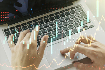 Poster - Multi exposure of abstract financial graph with hand typing on laptop on background, financial and trading concept