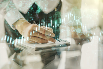 Poster - Multi exposure of abstract financial diagram with world map and with man hand writing in notepad on background, banking and accounting concept