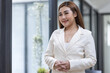 © David - Young asian woman, professional entrepreneur standing in office clothing, smiling and looking confident, workplace background
