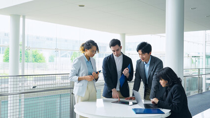 Wall Mural - A multinational group having a conversation in the lobby.
People in white coats and sales staff.