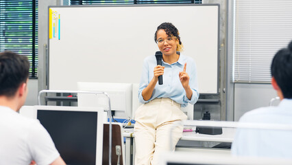 Female teacher teaching in class room. Business seminar.