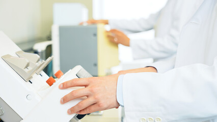 Poster - Group of researcher using experimental equipment.