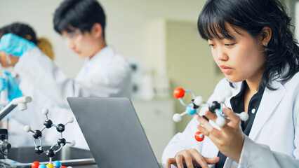 Poster - Multinational researcher group experimenting in the lab.