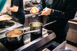 © pavel siamionov - Chef hands cooking cheese sauce in the restaurant kitchen