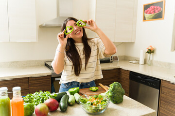 Excited woman making funny face while cooking vegan food