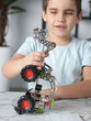 © ulianna19970 - little preteen boy play with steel mechanical constructor set close up photo