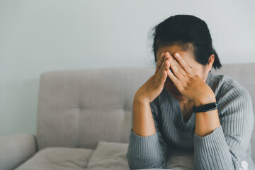 Wall Mural - Unhappy woman touching hair, sitting on floor at home, thinking about problems, upset girl feeling lonely and sad, psychological and mental troubles, suffering from bad relationship or break up