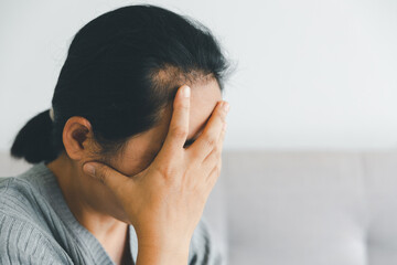 Wall Mural - Unhappy woman touching hair, sitting on floor at home, thinking about problems, upset girl feeling lonely and sad, psychological and mental troubles, suffering from bad relationship or break up